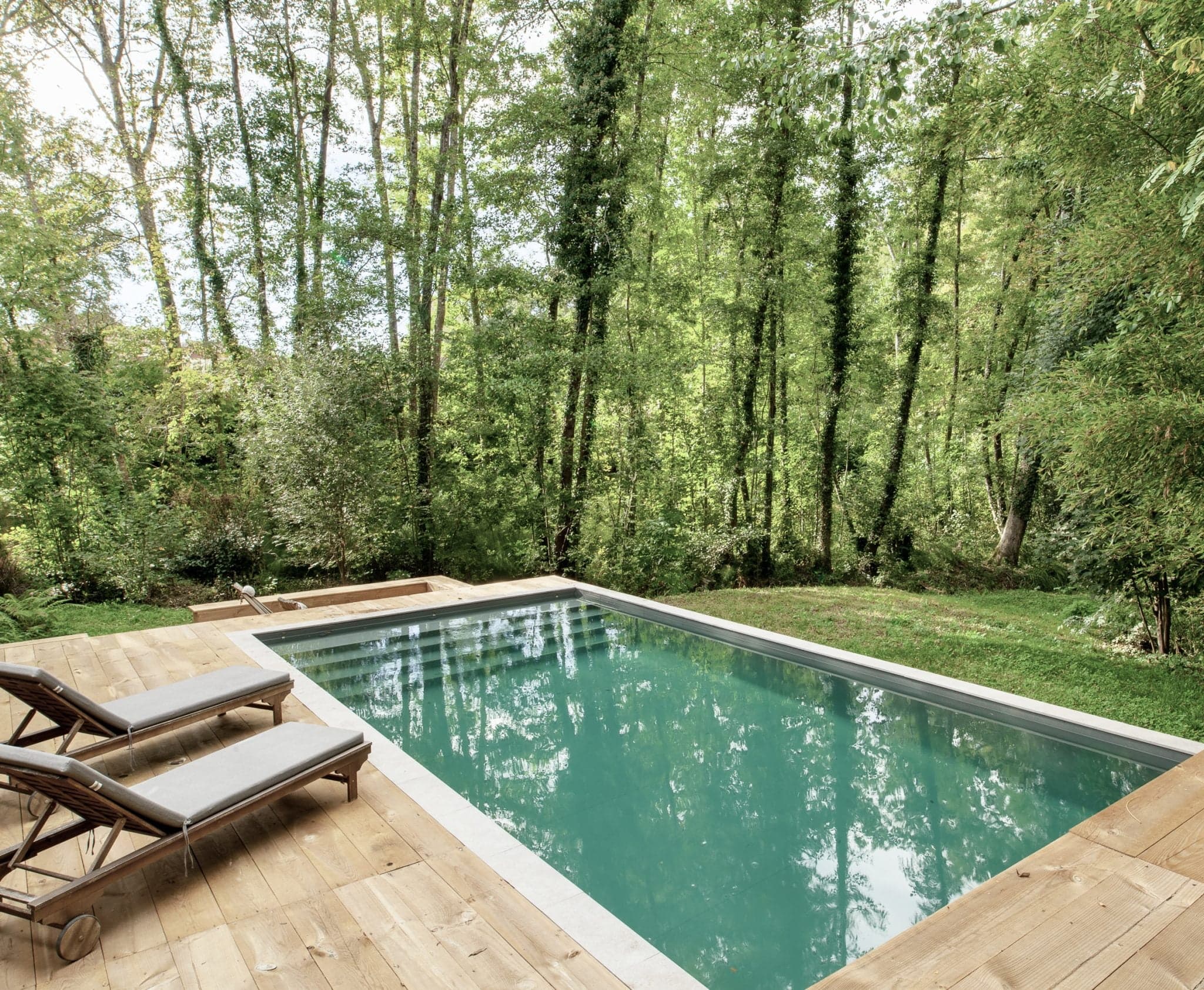 turquoise pool surrounded by nature