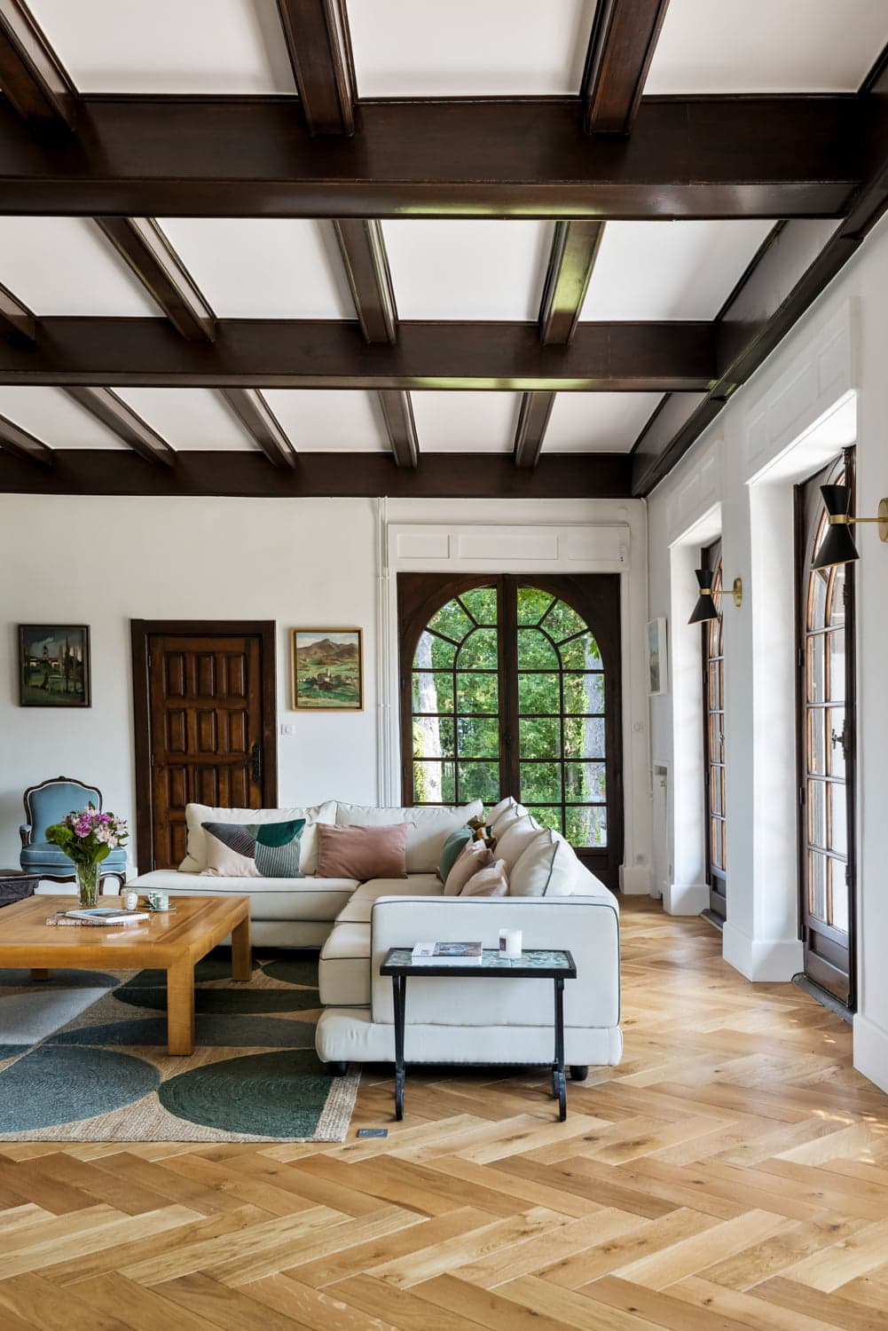 living room with parquet floor and ceiling beam