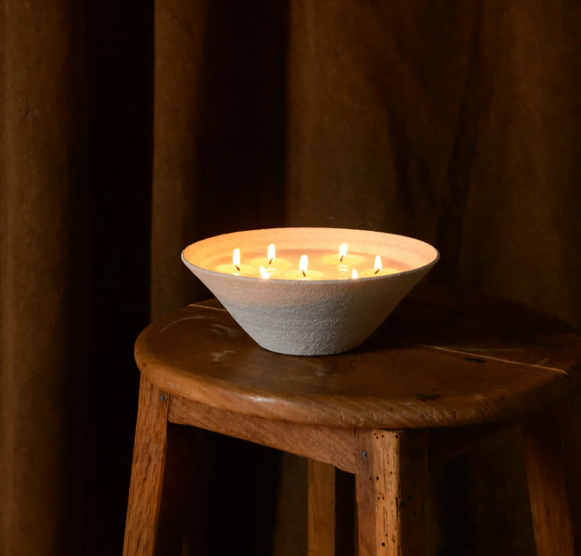 decorative round scented candle on a wooden stool