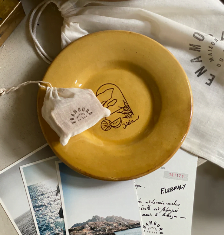 yellow ceramic plate and postcards