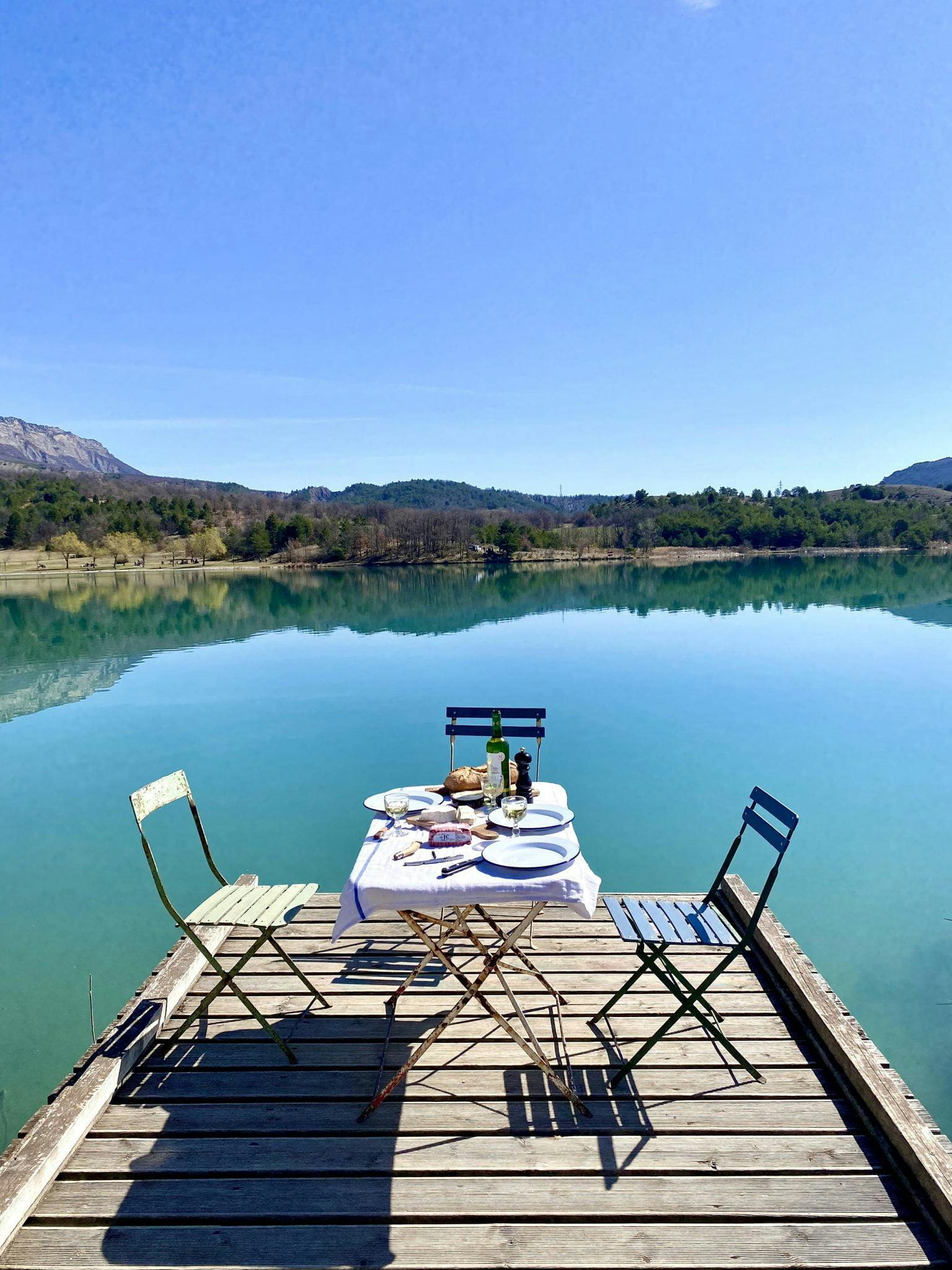 charmante table dressée au bord du ponton, superbe vue sur le lac