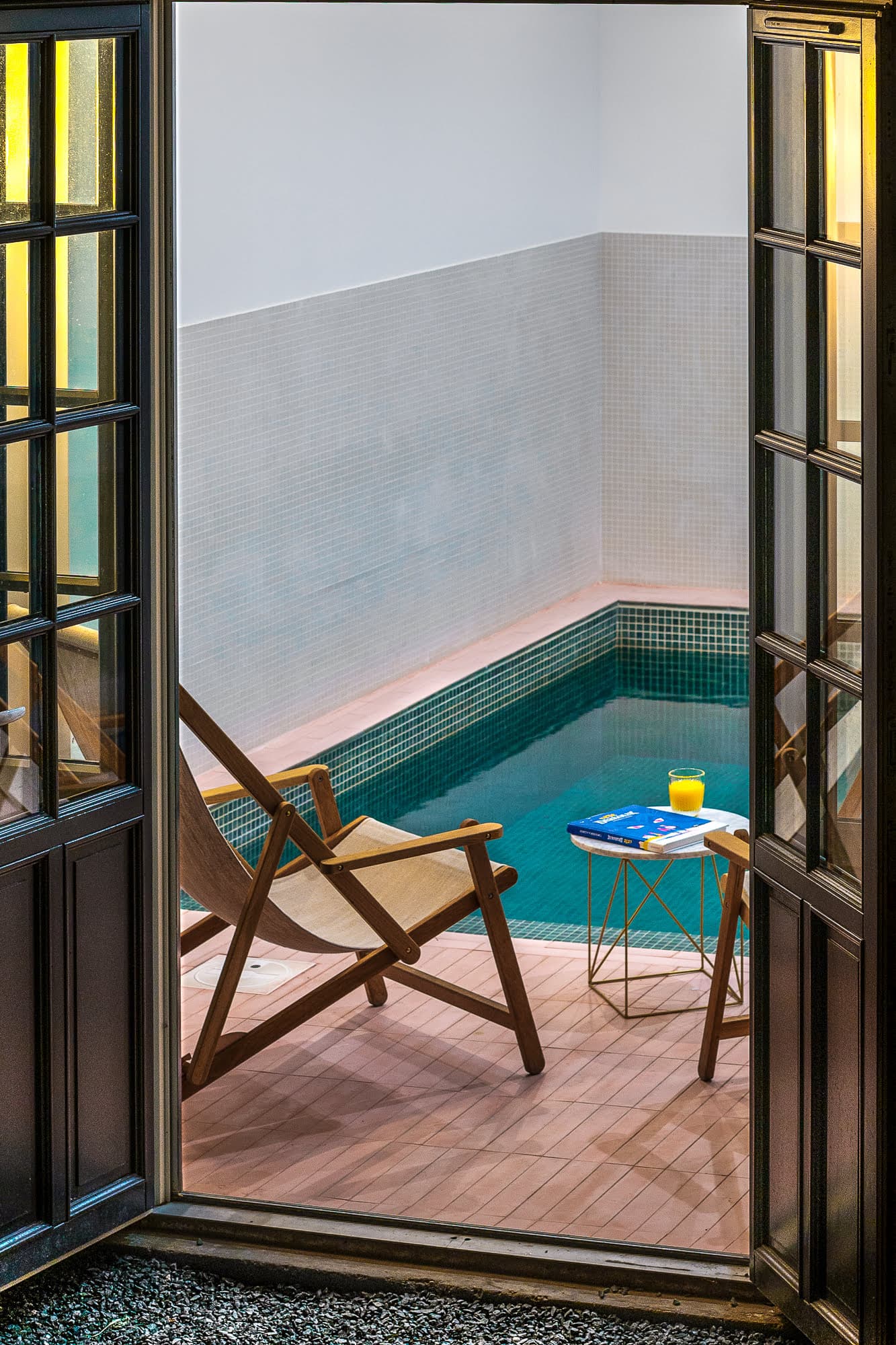 window overlooking the pool and deckchairs