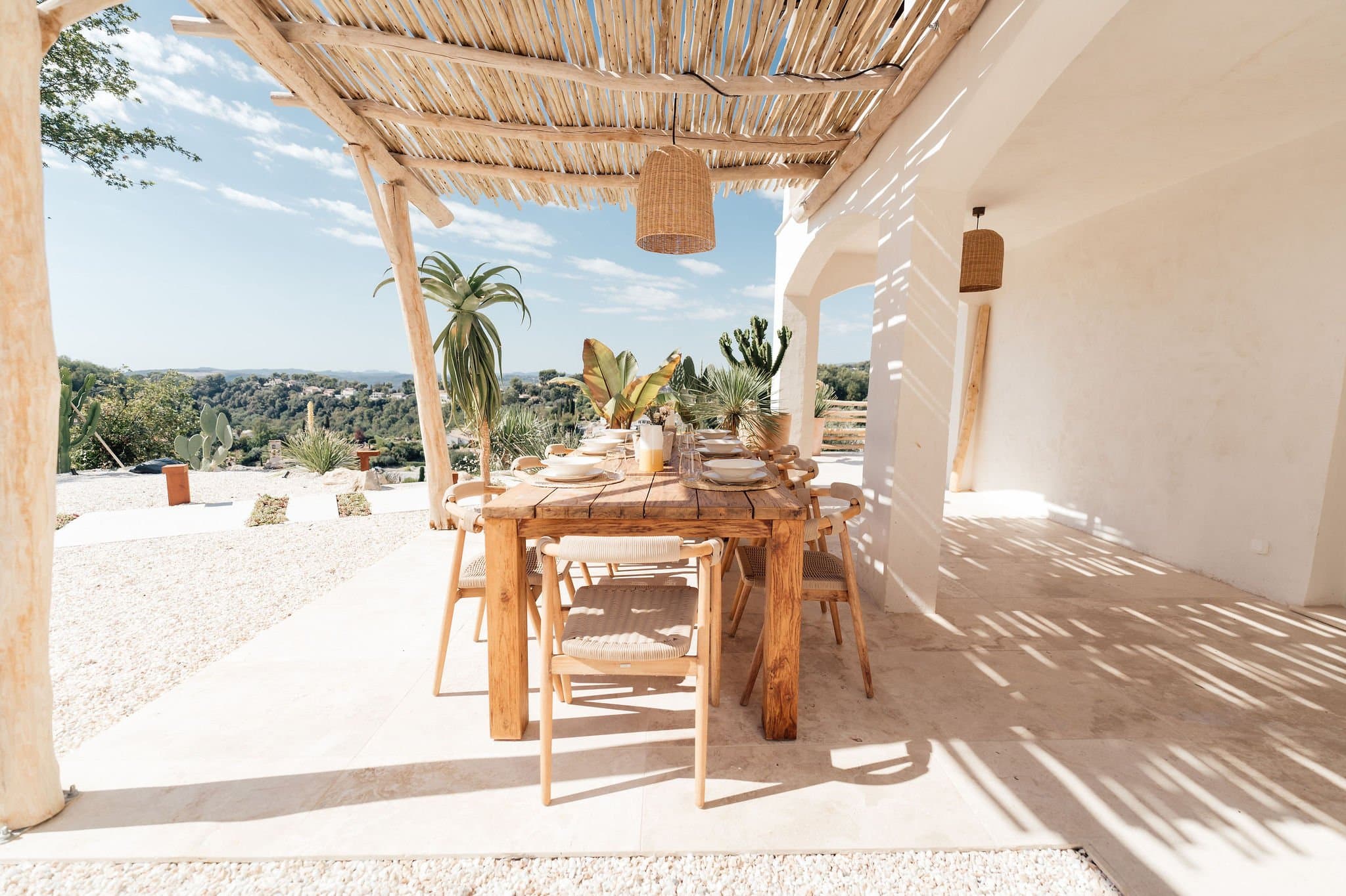 Outdoor dining table under the pergola, wide view