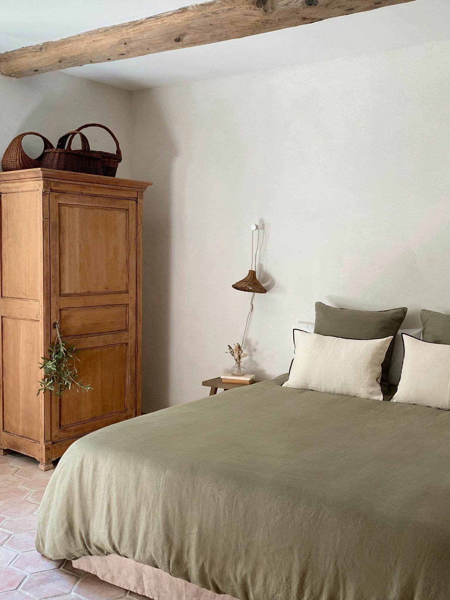 Whitewashed walls, double bed with green linen sheets, Provencal wardrobe