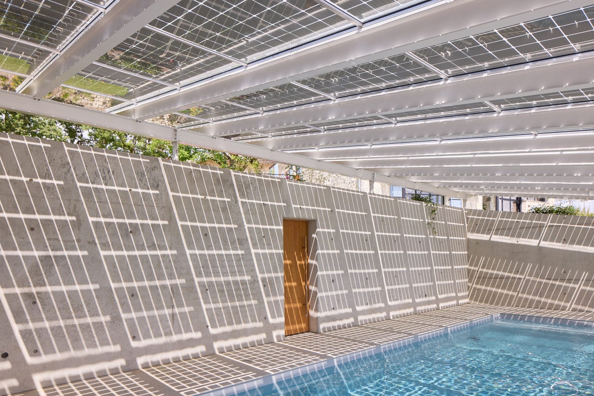 Pool, shade of awning and door to pool shower