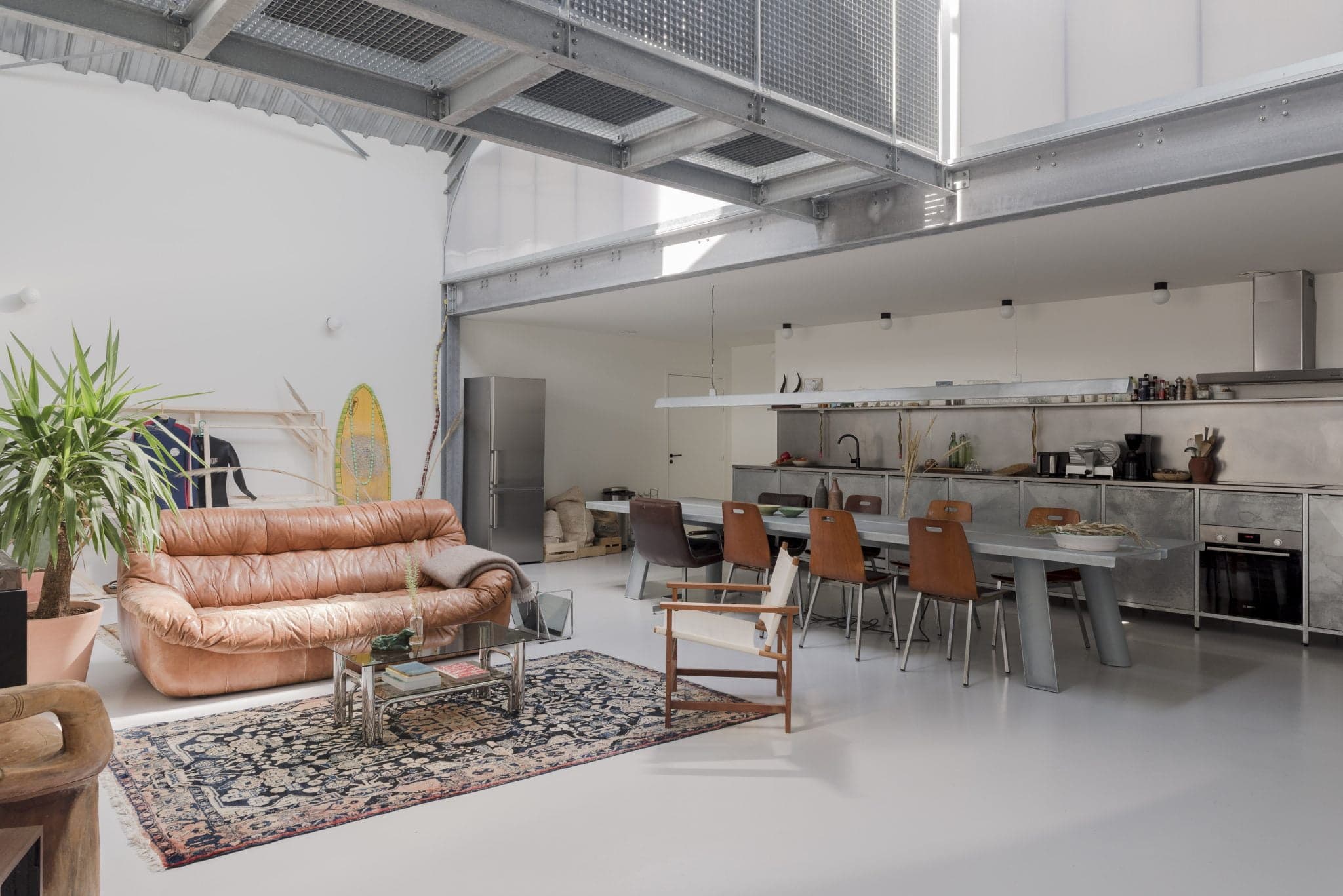 Skylight above leather sofa in West is the Best industrial loft