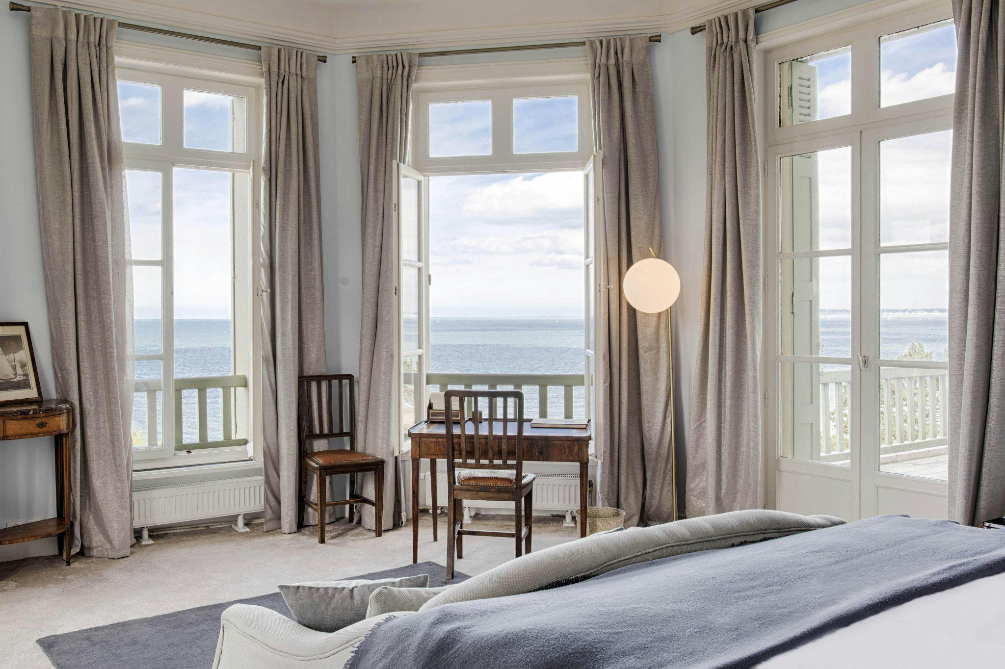 Window overlooking the sea in one of the corner bedrooms