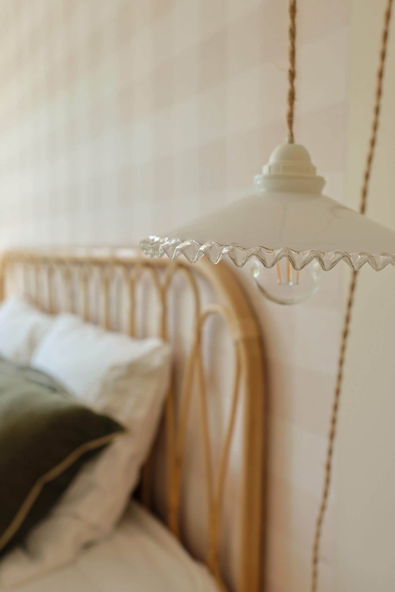 Romantic headboard and hanging lamp at La Bien Aimée