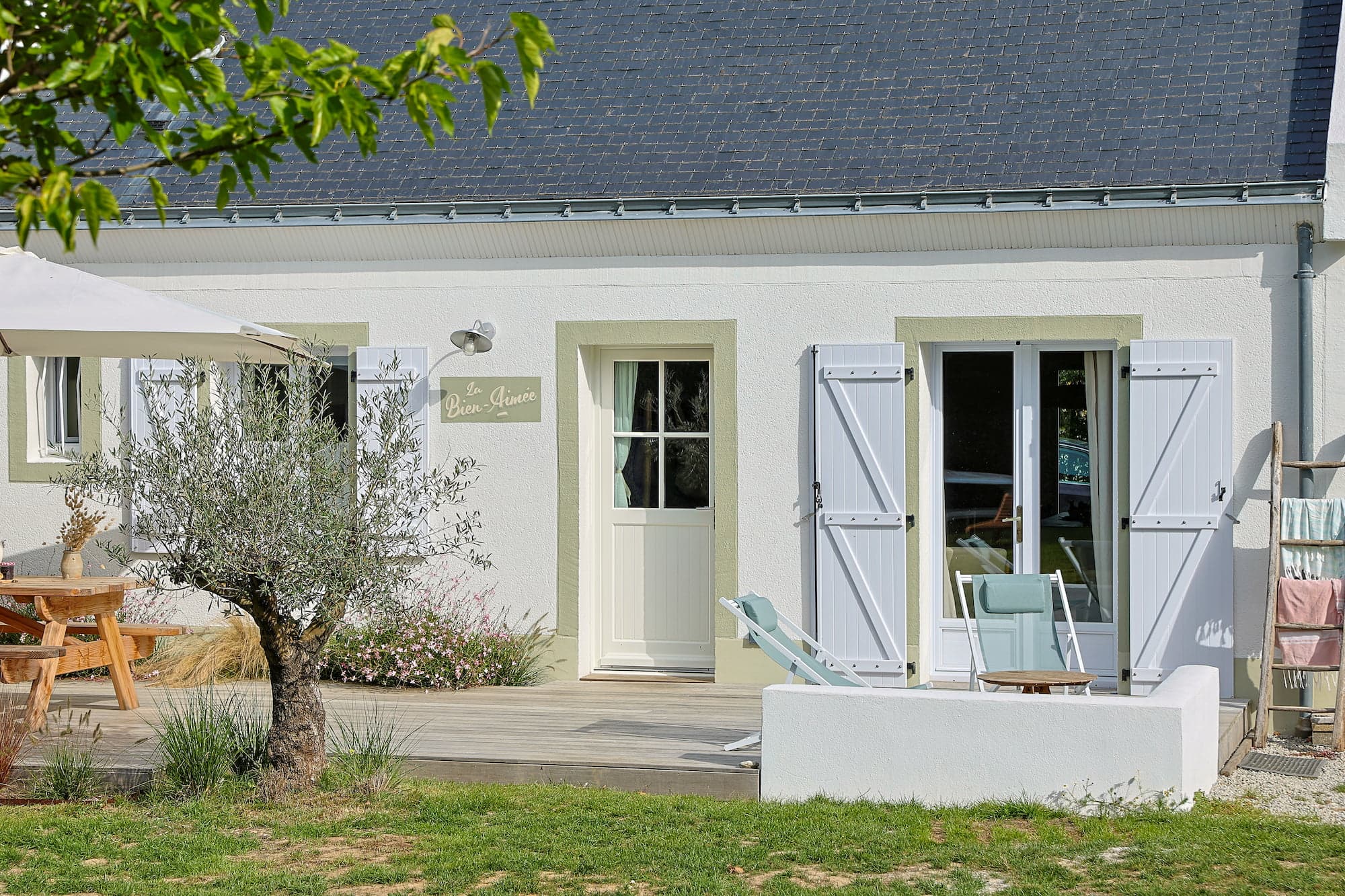 Front of La Bien Aimée with its light blue shutters