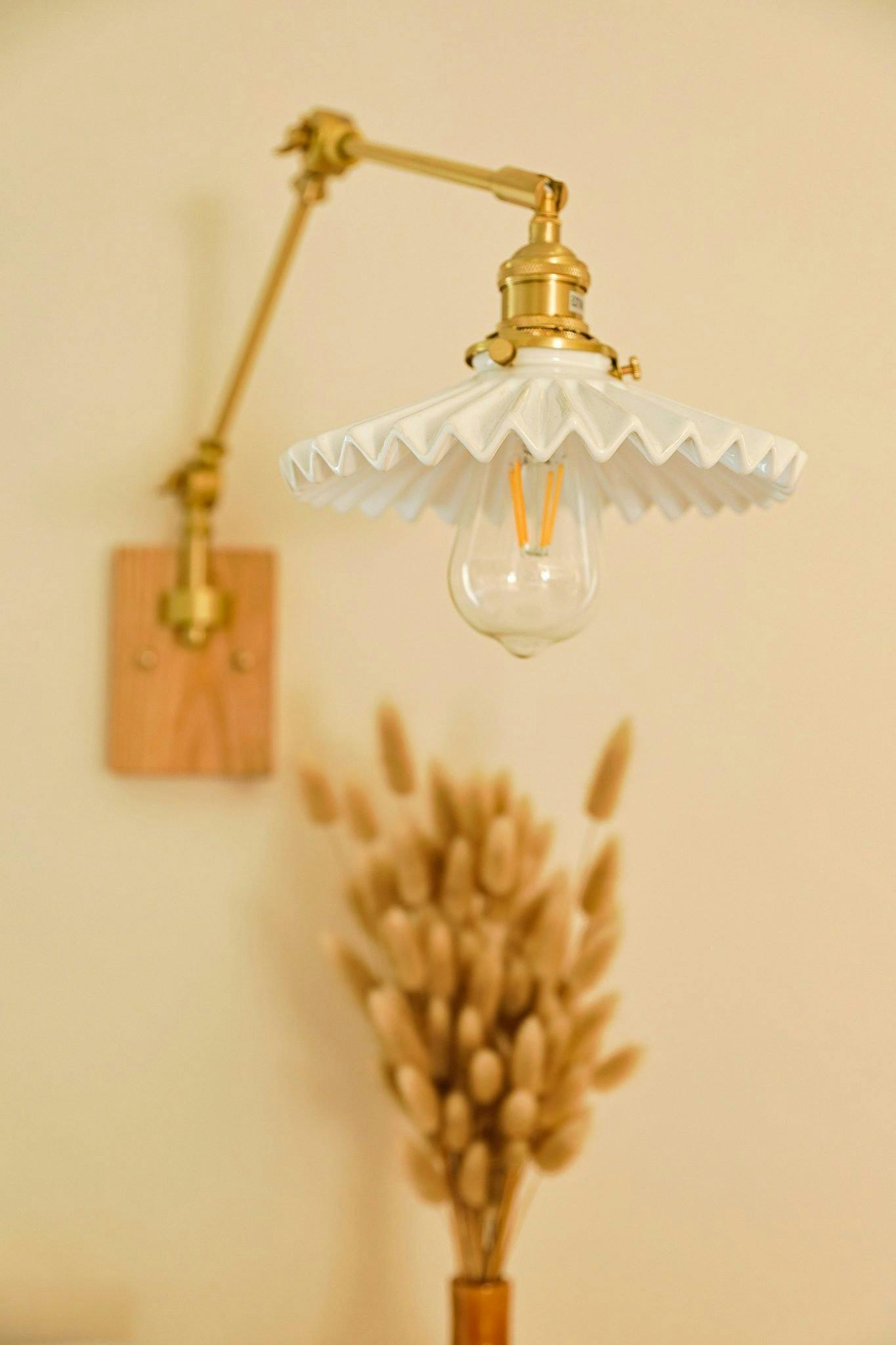 Décor: arm sconce and hanging lamp with dried flowers