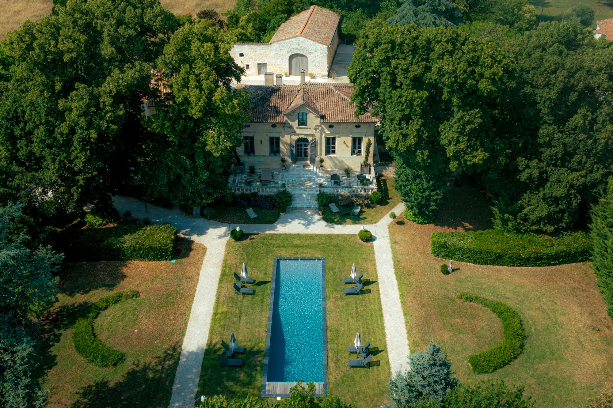 Aerial view of the Clos Marcamps estate with its swimming pool, manor house and outbuildings