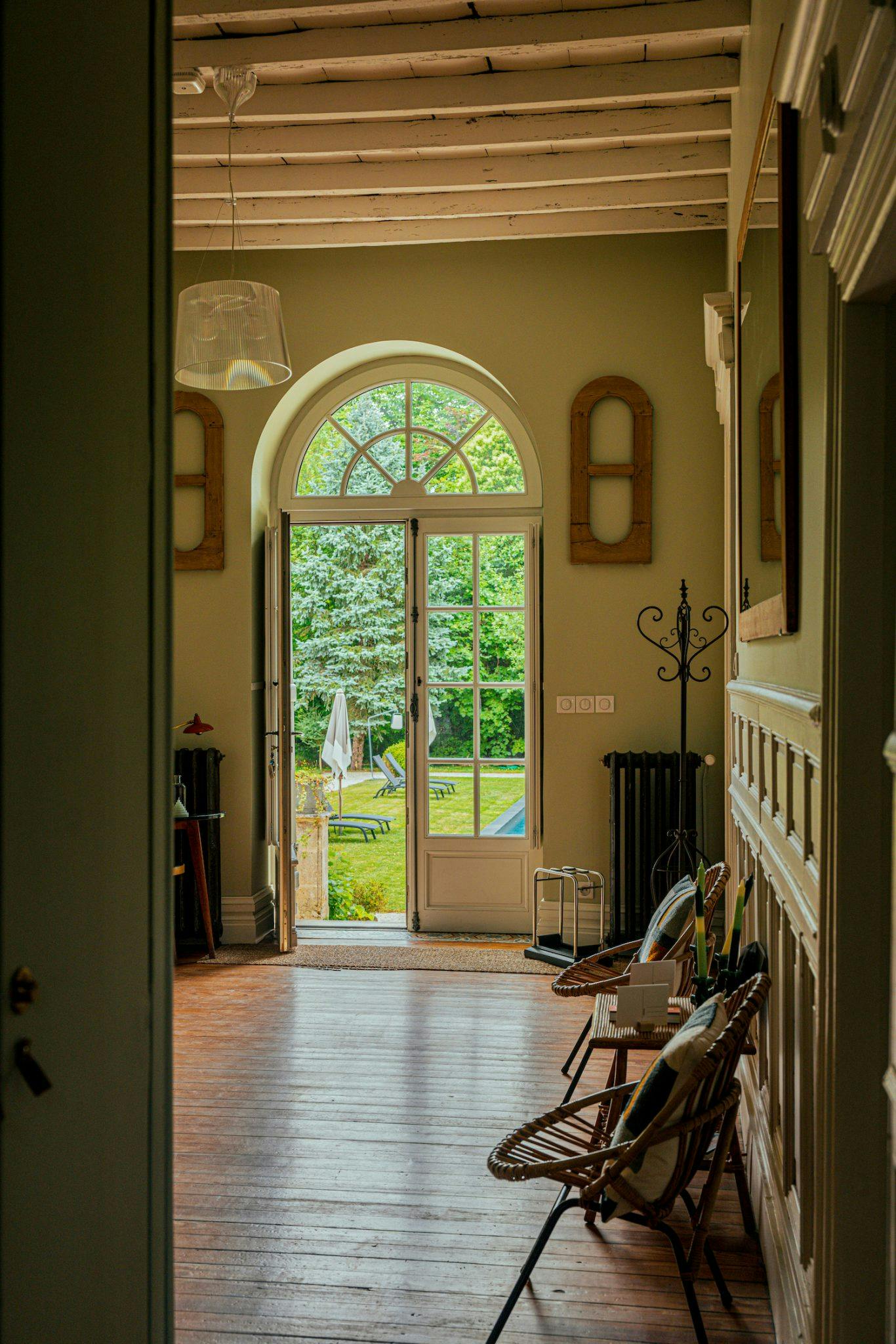 Entrance to the manor house, arched glass door and wood panelling