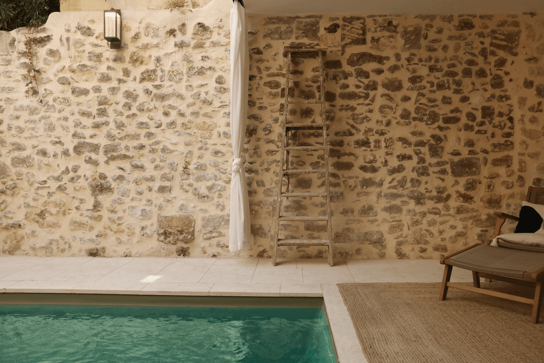 The stone wall along the pool