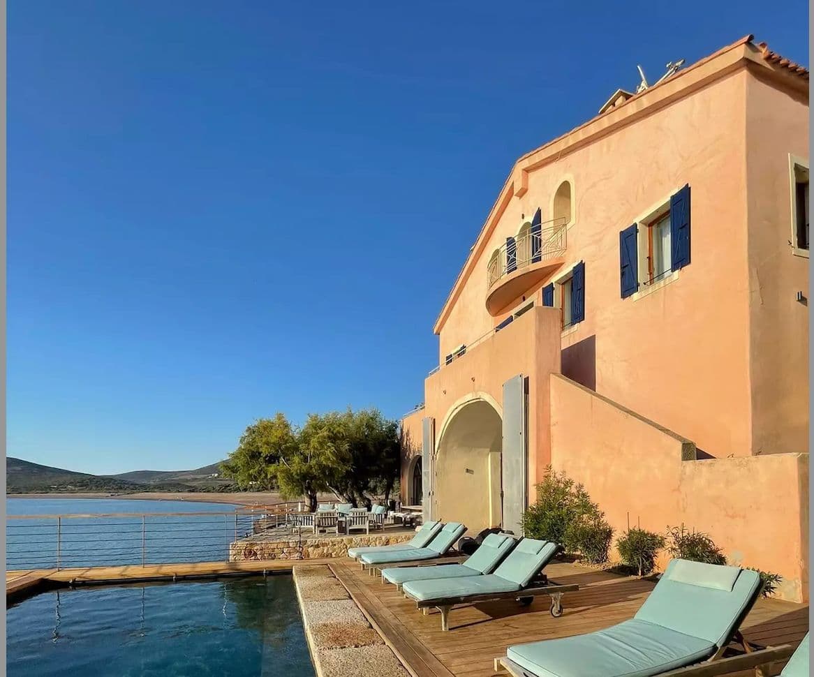 The swimming pool and blue lounge chairs on the terrace of Domaine d'Argentella