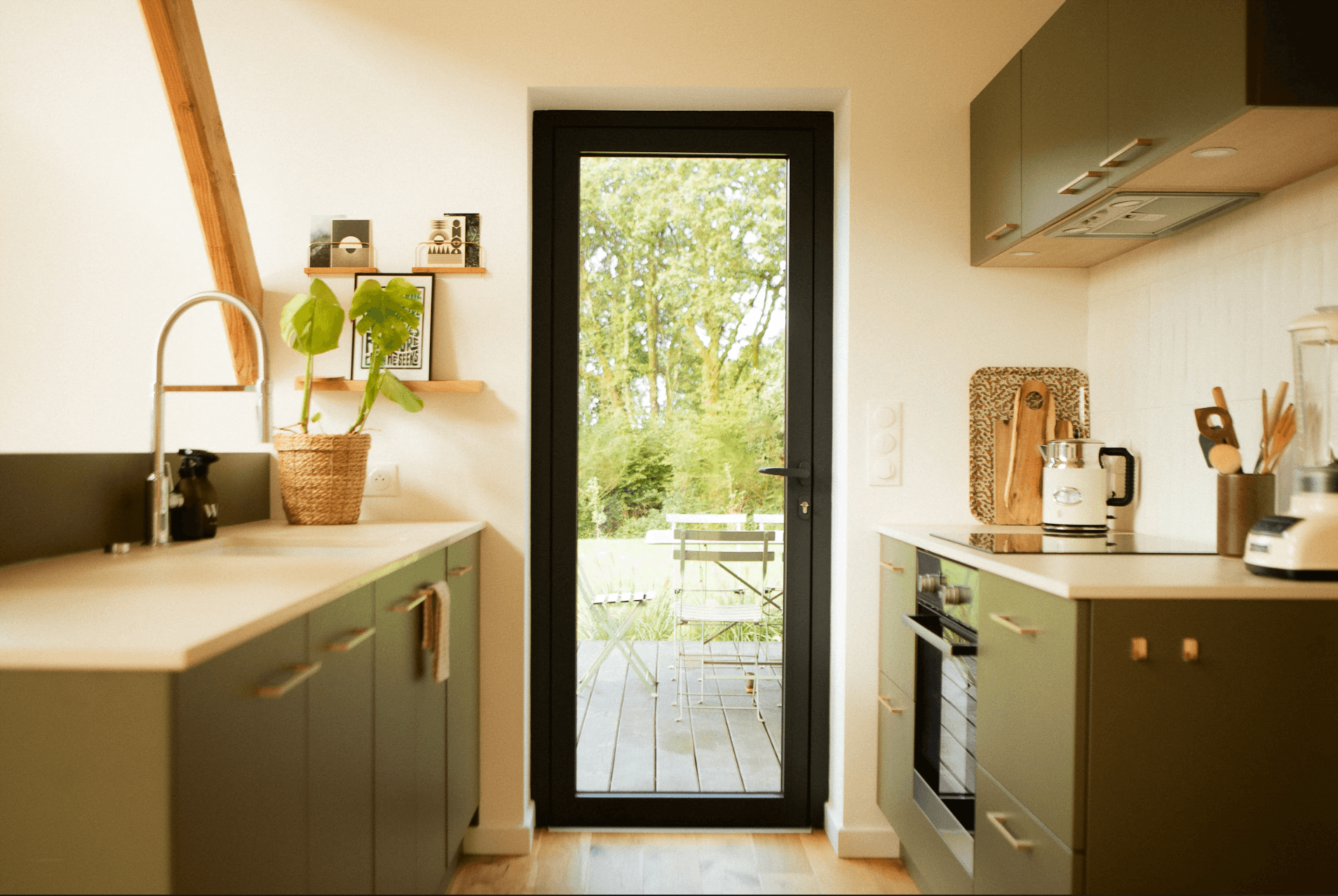 The kichen, green furniture, black door