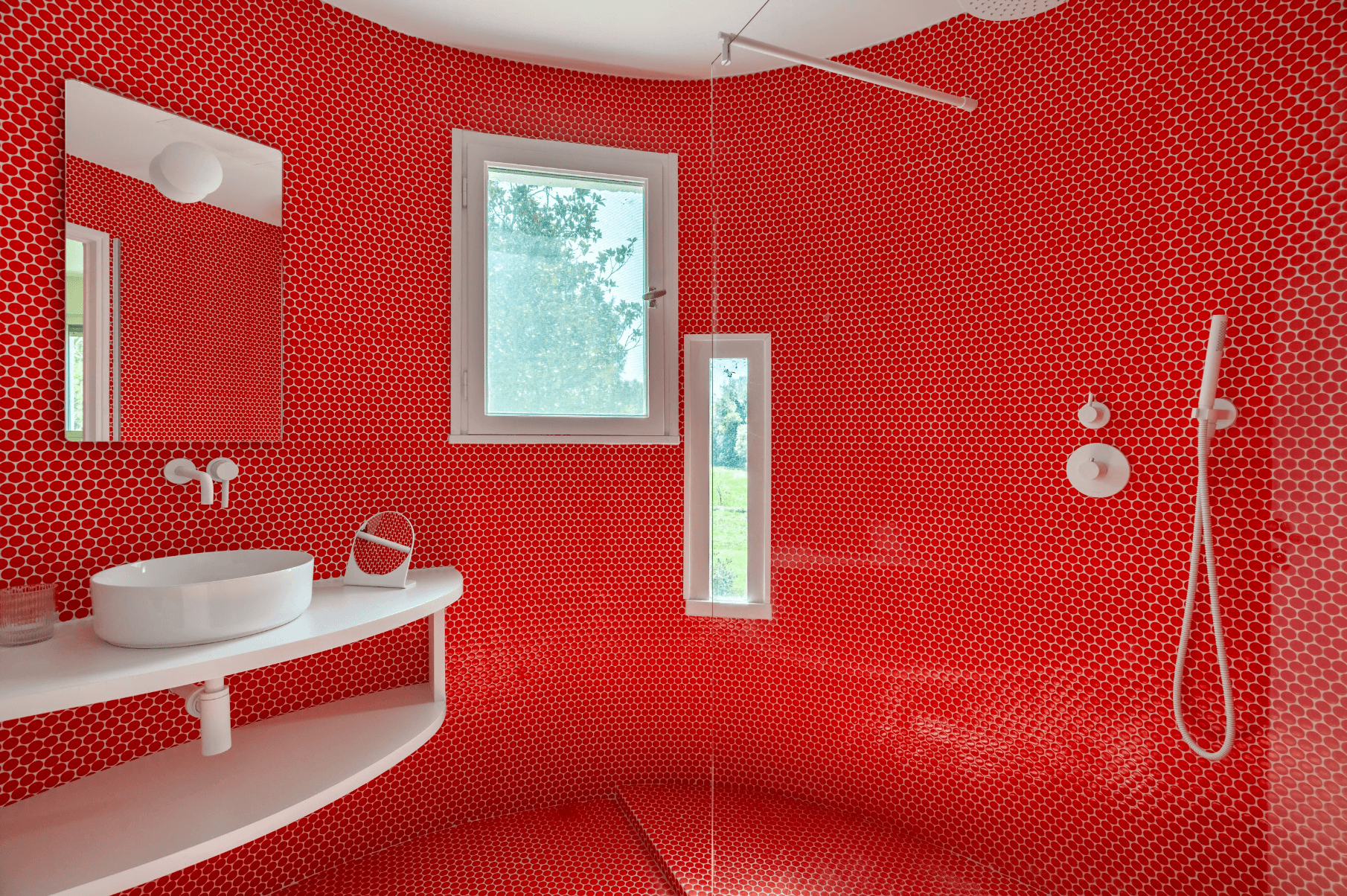 The bathroom with red mosaic tiles