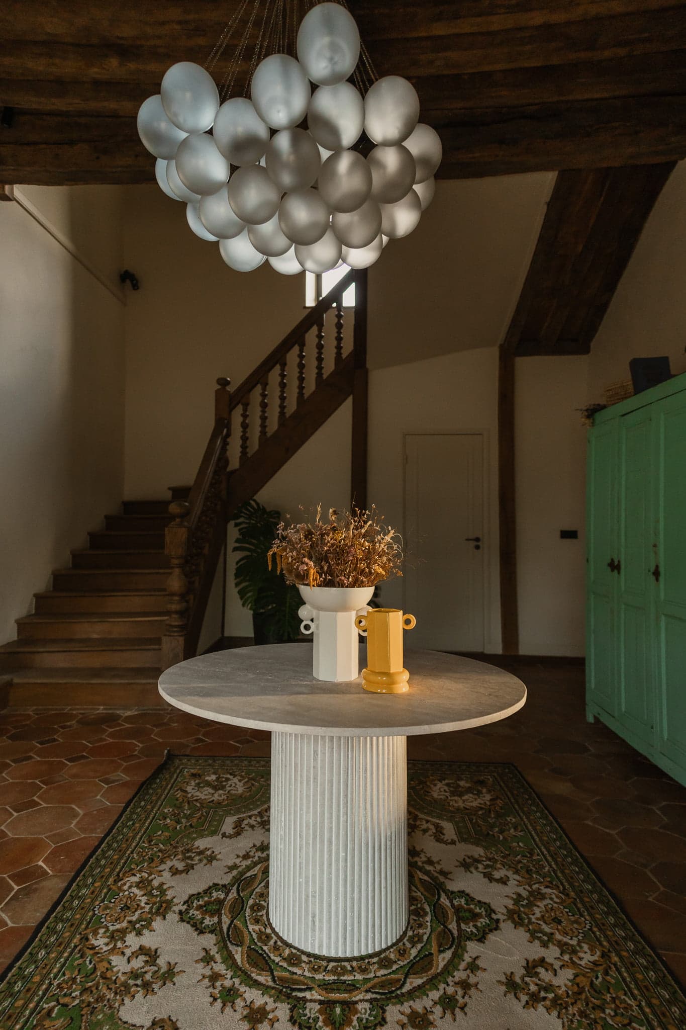 Dans l’entrée, lustre moderne, table en marbre, tapis marocain et tomettes se côtoient. © Nolwenn-Pernin