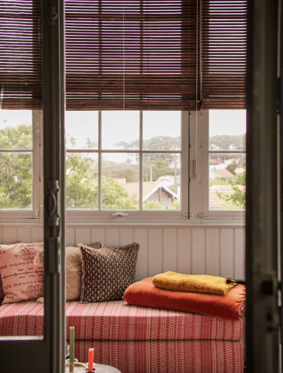 Detail of one of the verandas: glass door, benches, shutter