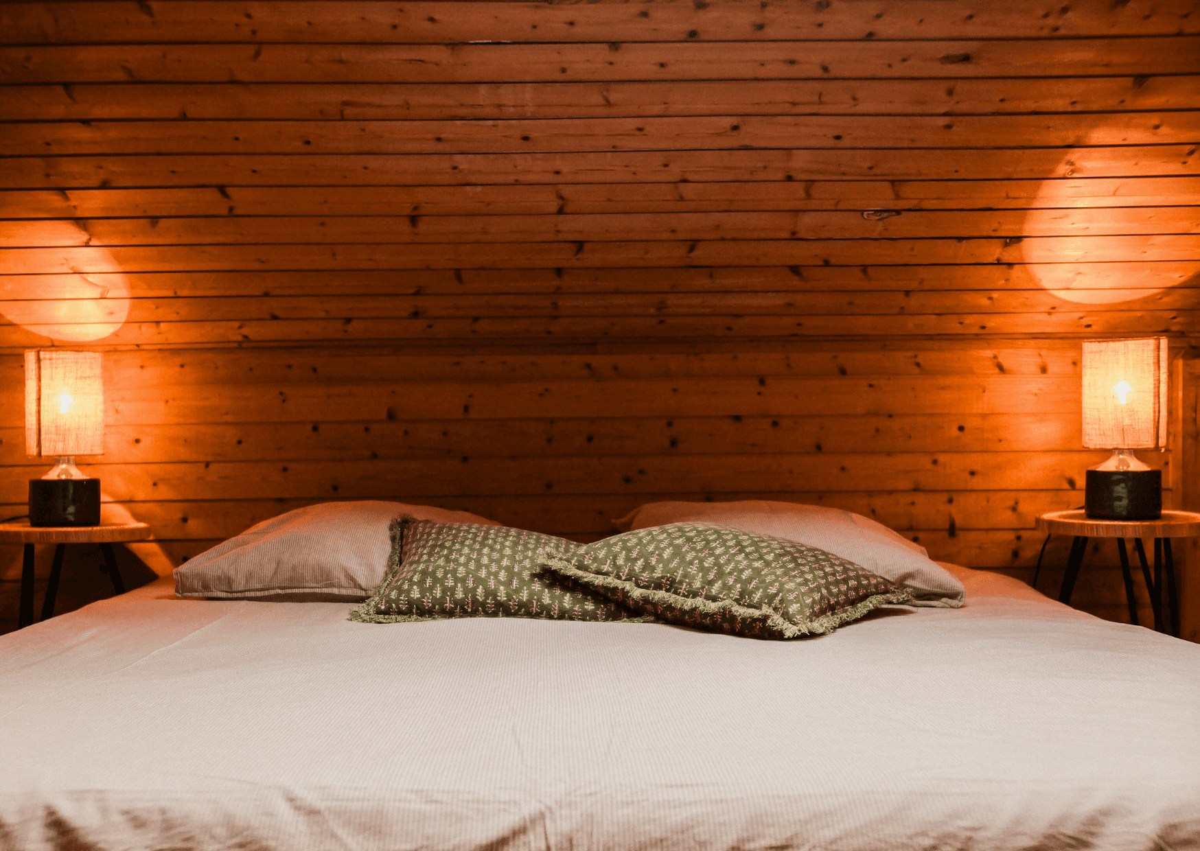 Double bed in the attic bedroom, wooden walls