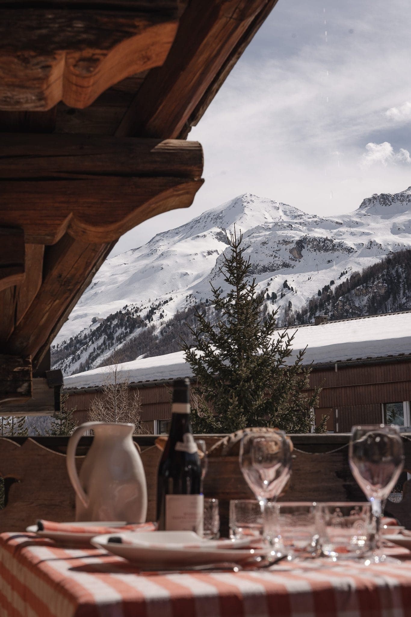 At the table, with a panoramic view of the mountains.