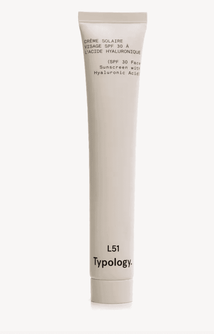 A minimalist white tube labeled with "Crème Solaire Visage SPF 30 à l'Acide Hyaluronique" and "SPF 30 Face Sunscreen with Hyaluronic Acid." The product is by Typology, designated as L51.