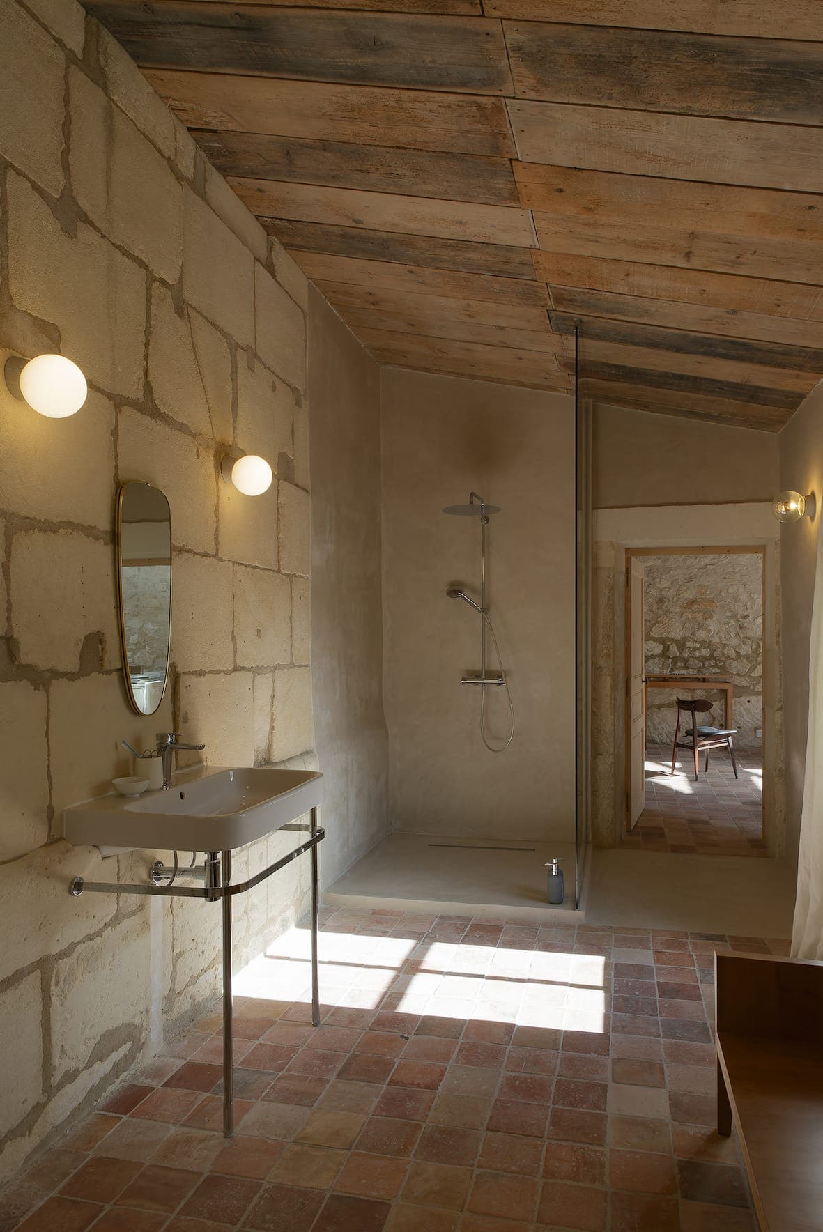 Minimalist stone bathroom with modern shower.