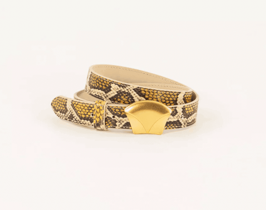 Une ceinture enroulée à motif peau de serpent marron et beige avec une boucle lisse en forme d'éventail dorée affichée sur un fond blanc.