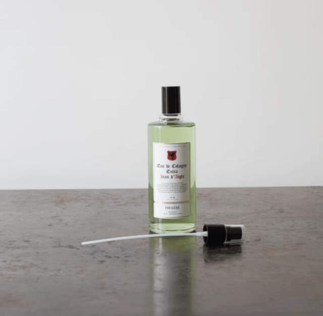 eau de cologne green bottle on a table