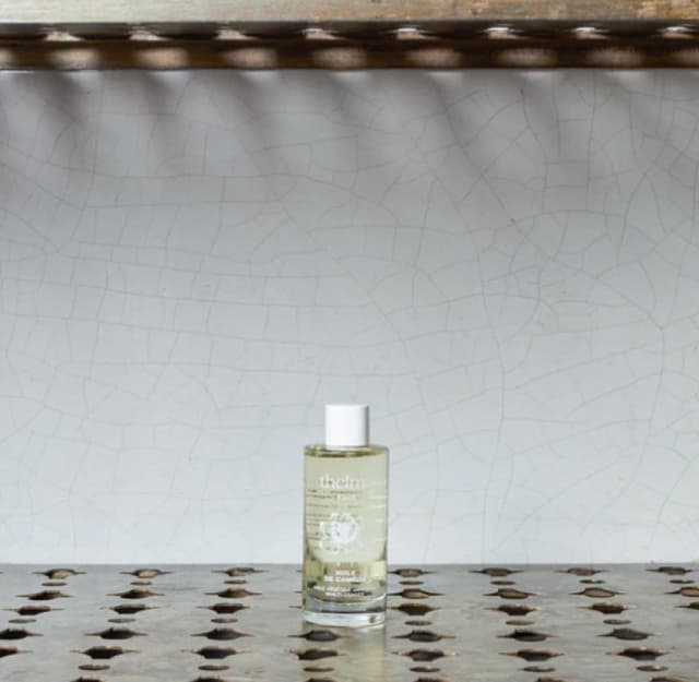 falon of camellia oil on a grey background