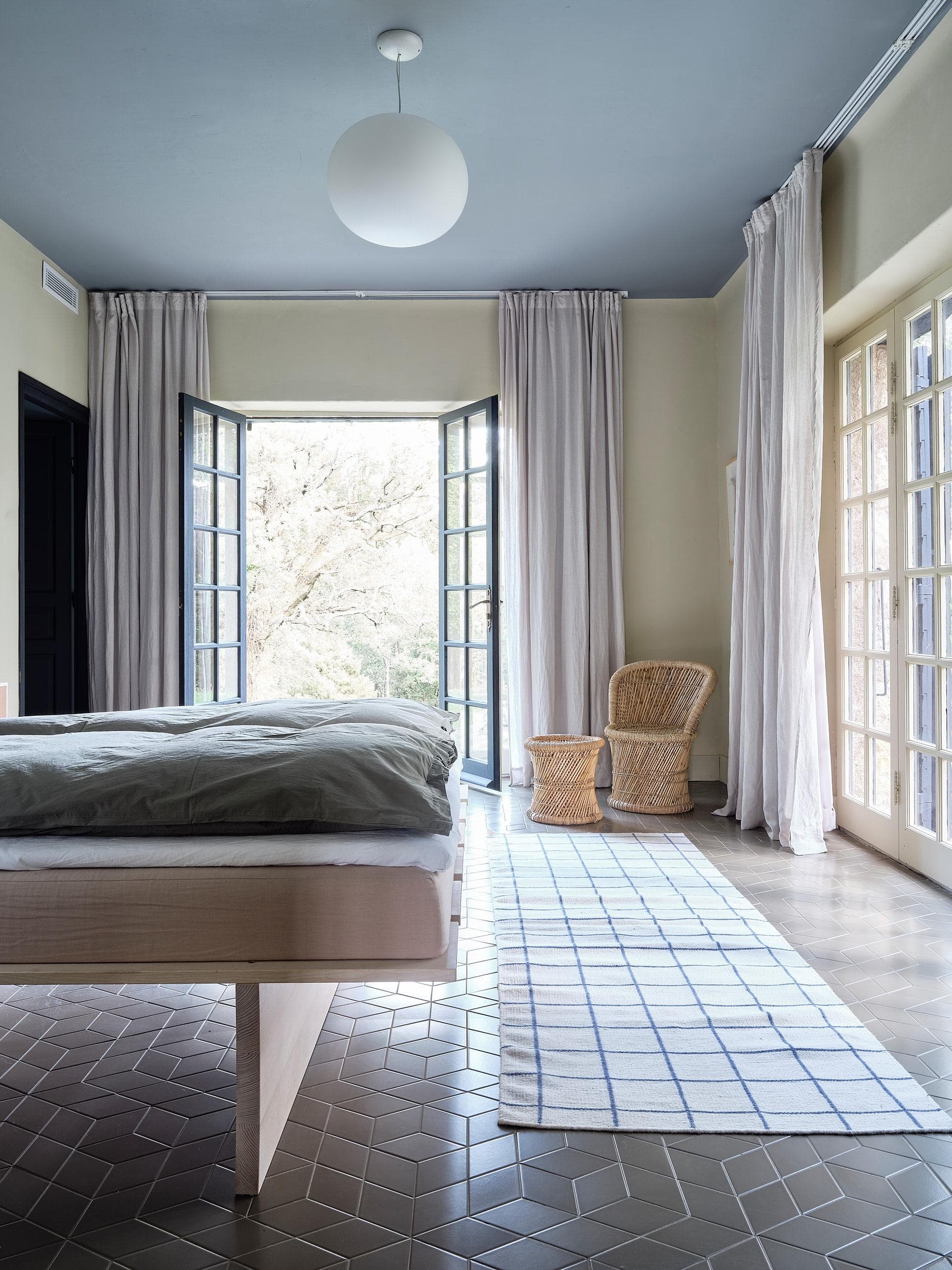 Bedroom with large window overlooking the garden