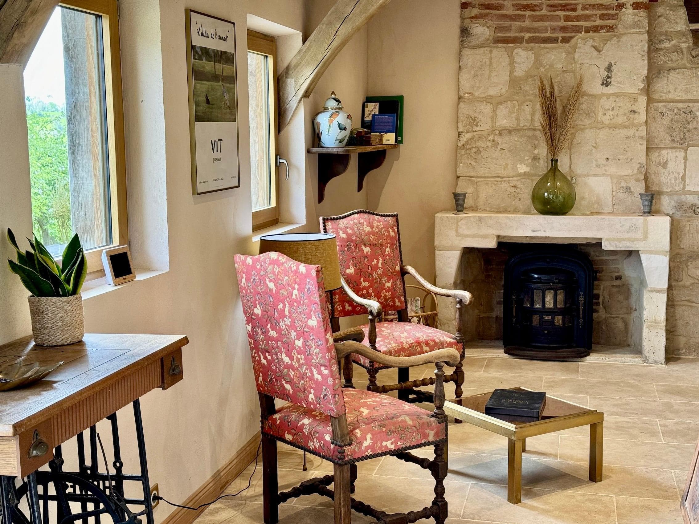 The charming living room where you can gather around the stove.