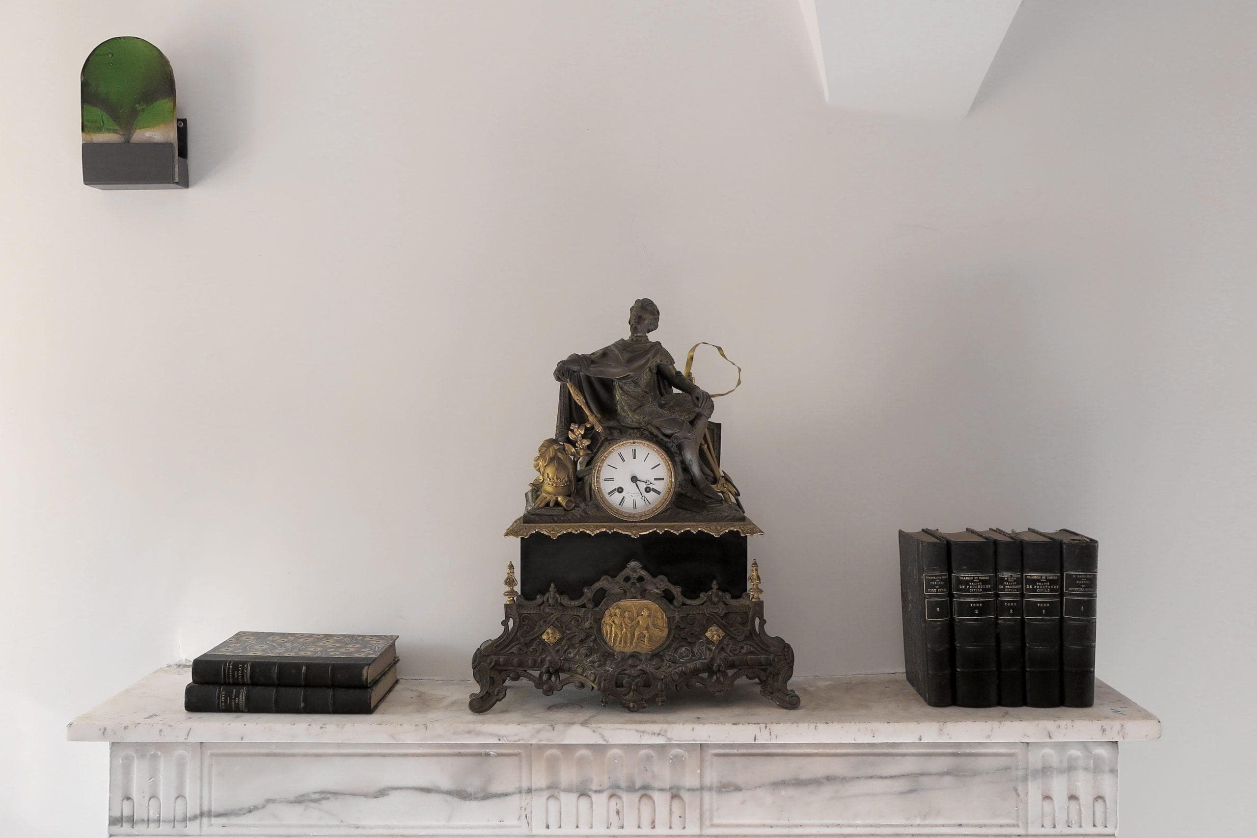 Marble mantel, custom-made wall lights and antique decorative pieces.