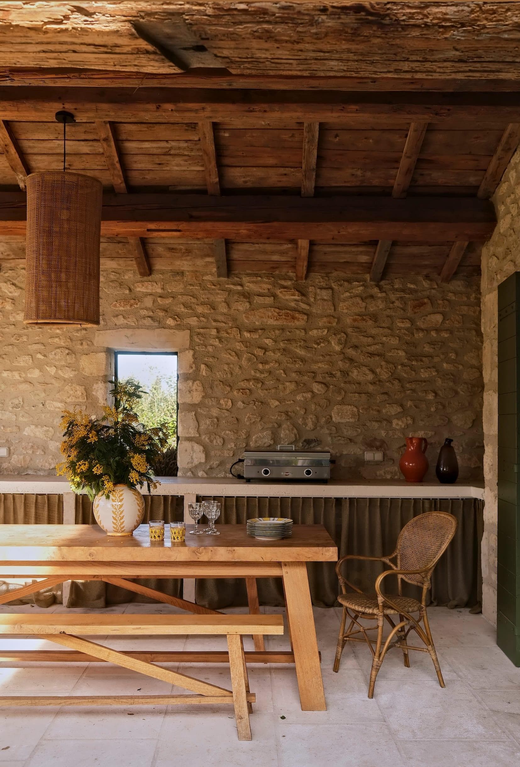 The charming stone-covered patio of La Maison au Pays des Alpilles.