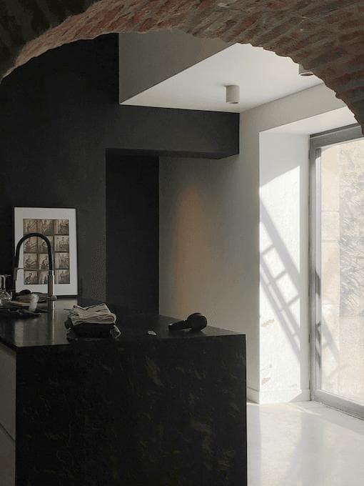 Beneath the stone arch, the beautiful contemporary kitchen.