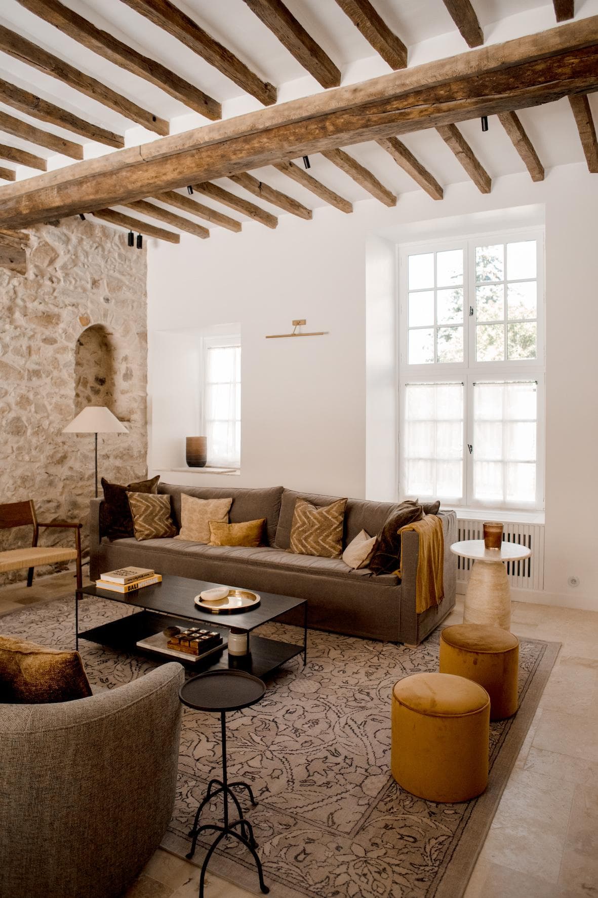 Relaxing vibes and exposed stone in the living room of Maison Avenita.